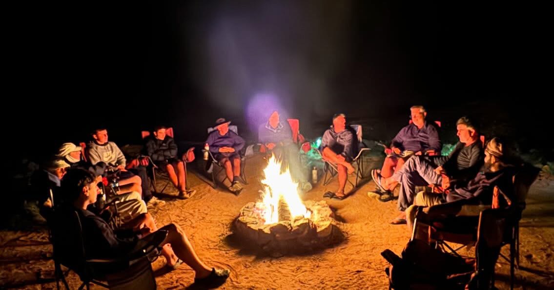 Travellers gather around a crackling campfire at the exclusive First Nations campsite on the Larapinta Trail. Stories are shared under the star-filled outback sky, creating moments of connection and reflection with Inspiration Outdoors.